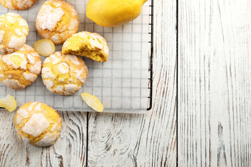 Cooling rack with delicious lemon cookies on white wooden table, flat lay. Space for text