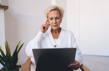 Woman working on computer in living room