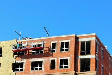 Work on additional insulation of the facade of a house under construction