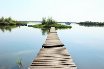 Wooden bridge to a small island in the lake