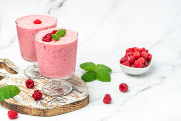 raspberries smoothie milkshake or yogurt in glass jar with berries. Yogurt cocktail on a white background. place for text, top view