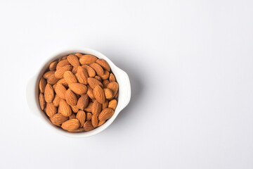 Almond roasted in bowl on white background , Healthy  food concept