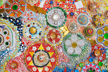 Colorful wall decorated with multicolor stone, gravel and gem for background at Wat Phra That Pha Son Kaew. Abstract of art design with broken tile for wallpaper.