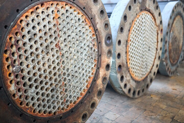 Corrosion, refinery heat exchanger chiller tubes with flange system. Two Industrial heat exchangers or boiler rusty tube sheet or tube board with deposits and corrosion at petrochemical enterprise