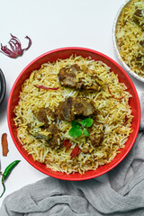 Delicious mutton biryani top view.Biryani rice dish Beautiful Indian rice dish.Delicious spicy chicken biryani in bowl over moody background, it’s a popular Indian and Pakistani food.