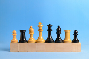 Chess pieces on wooden blocks..