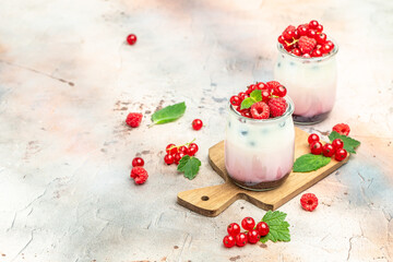 Raspberry dessert cheesecake, trifle, mouse in a glass. Raspberry Greek yogurt granola parfait on a light background. Restaurant menu, dieting, cookbook recipe