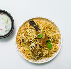 Delicious mutton biryani top view.Biryani rice dish Beautiful Indian rice dish.Delicious spicy chicken biryani in bowl over moody background, it’s a popular Indian and Pakistani food.