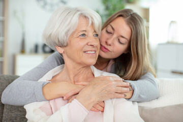 adult lady kissing her grandmother