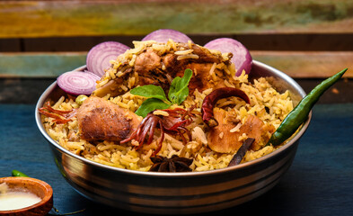 Delicious mutton biryani top view.Biryani rice dish Beautiful Indian rice dish.Delicious spicy chicken biryani in bowl over moody background, it’s a popular Indian and Pakistani food.