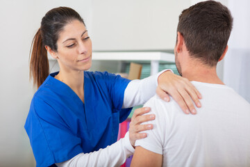 Fototapeta premium young female doctor helping male patient