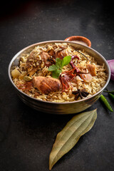 Delicious mutton biryani top view.Biryani rice dish Beautiful Indian rice dish.Delicious spicy chicken biryani in bowl over moody background, it’s a popular Indian and Pakistani food.