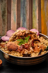 Delicious mutton biryani top view.Biryani rice dish Beautiful Indian rice dish.Delicious spicy chicken biryani in bowl over moody background, it’s a popular Indian and Pakistani food.