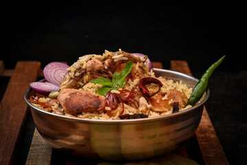 Delicious mutton biryani top view.Biryani rice dish Beautiful Indian rice dish.Delicious spicy chicken biryani in bowl over moody background, it’s a popular Indian and Pakistani food.