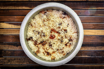 Delicious mutton biryani top view.Biryani rice dish Beautiful Indian rice dish.Delicious spicy chicken biryani in bowl over moody background, it’s a popular Indian and Pakistani food.