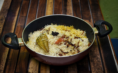 Delicious mutton biryani top view.Biryani rice dish Beautiful Indian rice dish.Delicious spicy chicken biryani in bowl over moody background, it’s a popular Indian and Pakistani food.