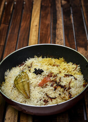 Delicious mutton biryani top view.Biryani rice dish Beautiful Indian rice dish.Delicious spicy chicken biryani in bowl over moody background, it’s a popular Indian and Pakistani food.