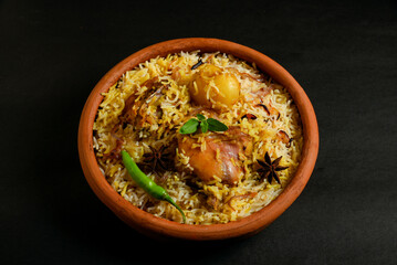 Delicious mutton biryani top view.Biryani rice dish Beautiful Indian rice dish.Delicious spicy chicken biryani in bowl over moody background, it’s a popular Indian and Pakistani food.