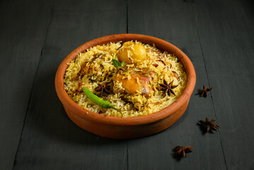 Delicious mutton biryani top view.Biryani rice dish Beautiful Indian rice dish.Delicious spicy chicken biryani in bowl over moody background, it’s a popular Indian and Pakistani food.