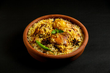 Delicious mutton biryani top view.Biryani rice dish Beautiful Indian rice dish.Delicious spicy chicken biryani in bowl over moody background, it’s a popular Indian and Pakistani food. - obrazy, fototapety, plakaty