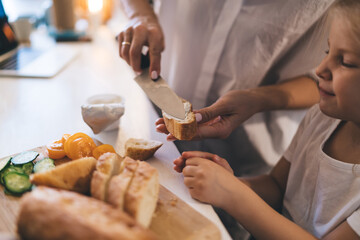 Mother and daughter preparing healthy breakfast in kitchen at home