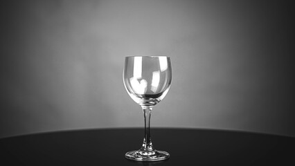 Pour pure drinking water into a glass. a glass with water set on a gray background.