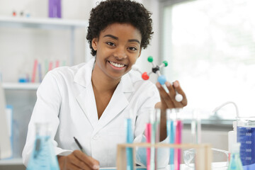 female scientist holding a model molecule