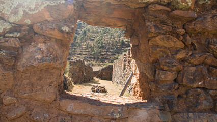 window in stone inca home looking in Pumamarka, Cusco Peru