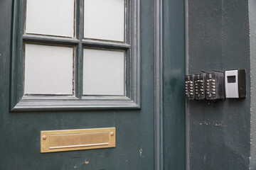 Electronic keypad locking system on the wall outside of a residential house, where each floor is rented anonymously only on time. Tourism private hotel house in Emden, Lower Saxony, Germany.