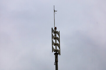 High power speaker arrays mounted on a pole for military or emergency alerts.