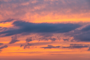 Naklejka na ściany i meble orange gold sunset ,dramatic fluffy clouds at pink evening sky nature landscape