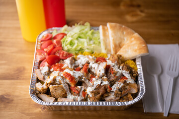 chicken over rice in aluminum bowl, new york style famous halal food