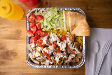chicken over rice in aluminum bowl, new york style famous halal food
