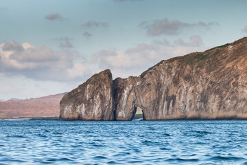 sea and rocks with an arch, San Cristobal, Galapagos Islands