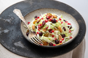 Fresh salad with cabbage, cranberries, raisins and peanuts	