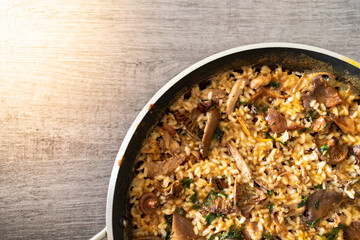 Aerial view of a delicious mountain rice with sirloin and mushrooms. Traditional Spanish homemade food.