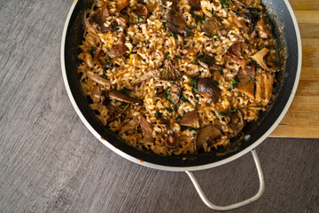 Aerial view of a delicious mountain rice with sirloin and mushrooms. Traditional Spanish homemade food.