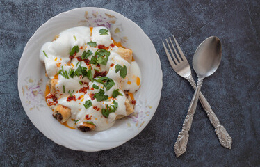 Turkish ravioli with yufka, yoghurt and minced meat; Its Turkish name is yufkalı high society ravioli.