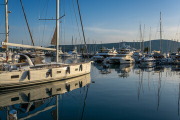 Moored yachts and motorboats at sunset