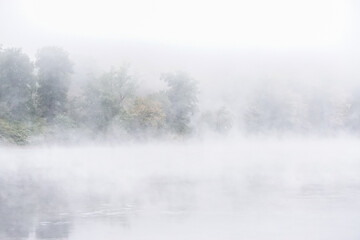 Fototapeta na wymiar Shawnee on Delaware, Pennsylvania: Early morning mist rising from waters of the Delaware River, in the Delaware Water Gap.