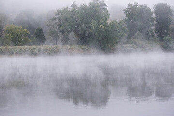Obraz na płótnie Canvas Shawnee on Delaware, Pennsylvania, USA: Early morning mist rising from waters of the Delaware River, in the Delaware Water Gap.