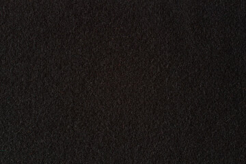 Black color felt textile fabric texture background. Top view