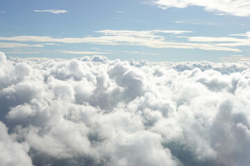 Aerial View from Airplane with City Scape below the Clouds