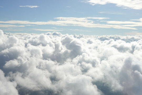 Aerial View from Airplane with City Scape below the Clouds © foreverhappy
