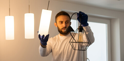 Home Ceiling Light Equipment Maintenance. Professional Electrician Worker.
