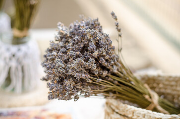 Beautiful fragrant bouquets of dried lavender stand in a beautiful vintage macrame jar and basket