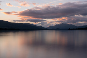 Fototapeta na wymiar Beautiful sunset over Loch Lomond during late summer time with Ben Lomond standing high in the background