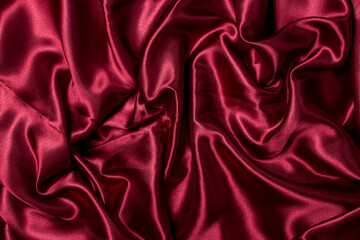 Crumpled red fabric as a background for the image. Texture of red textile material