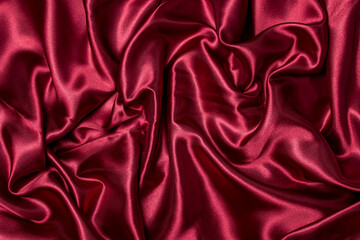Crumpled red fabric as a background for the image. Texture of red textile material