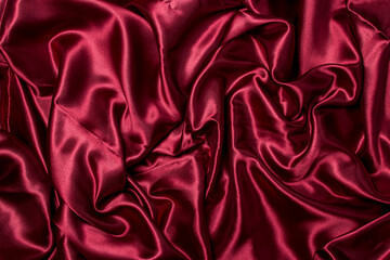 Obraz premium Crumpled red fabric as a background for the image. Texture of red textile material
